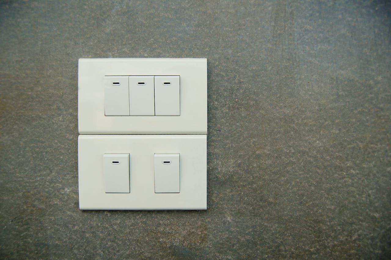 White Light Rocker Switches on Gray Wall